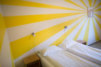 a bedroom with a striped wall with a bed at Lyngmo Gjestehus in Hafslo