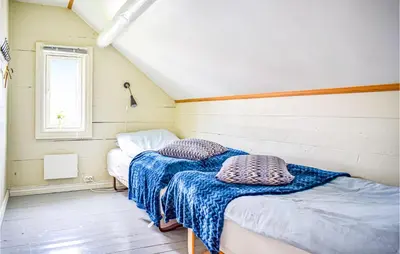 two beds in a small room with a window at Lovely Home In Hebnes With Wifi in Hebnes