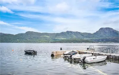 a group of boats parked at a dock on a lake at Lovely Home In Hebnes With Wifi in Hebnes