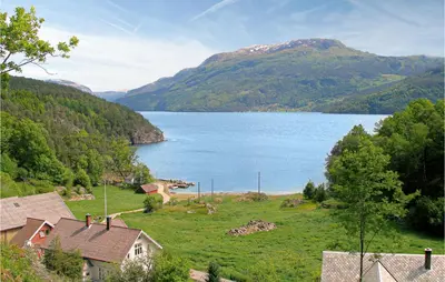a view of a large body of water with mountains at Sjøhytta in Vanvik