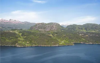 an aerial view of a large body of water with mountains at Sjøhytta in Vanvik