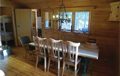 a dining room with a table and chairs in a cabin at Roligheten in Vanvik