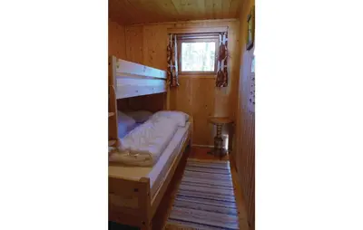a small room with a bed and a window at Roligheten in Vanvik