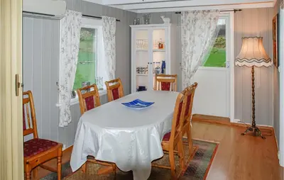 a dining room with a white table and chairs at 3 Bedroom Awesome Home In Skjold in Skjold
