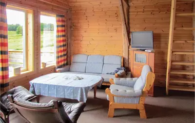 a living room with a table and a tv in a cabin at Holiday Home Bjoa Haugsgjerdet in Utbjoa