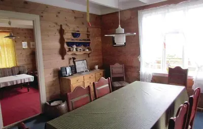 a dining room with a table and chairs and a window at Holiday Home Bjoa Haugsgjerdet Ii in Utbjoa