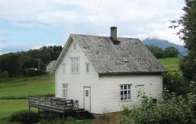an old white house in a field of grass at Holiday Home Bjoa Haugsgjerdet Ii in Utbjoa