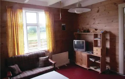 a living room with a couch and a television at Holiday Home Bjoa Haugsgjerdet Ii in Utbjoa