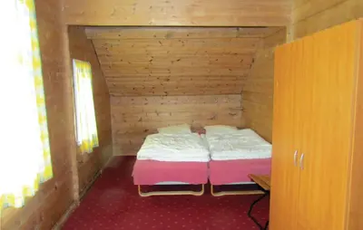 a small room with a bed in a wooden cabin at Holiday Home Bjoa Haugsgjerdet Ii in Utbjoa