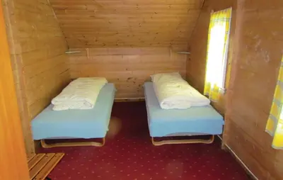 two beds in a wooden room with a window at Holiday Home Bjoa Haugsgjerdet Ii in Utbjoa