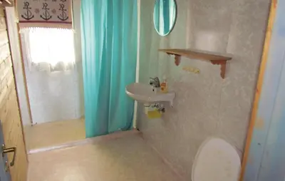 a bathroom with a sink and a toilet and a mirror at 3 Bedroom Gorgeous Home In Bjoa in Utbjoa