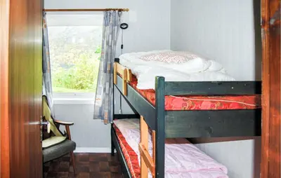 two bunk beds in a room with a window at Ytre Matre in Hamre
