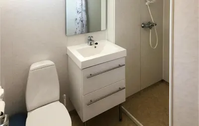 a bathroom with a white sink and a toilet at Kyrping Ferieplass A in Erve