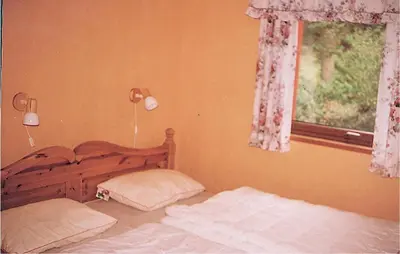 a bedroom with a bed and a window at Holiday Home Etne Sørstranda in Erve