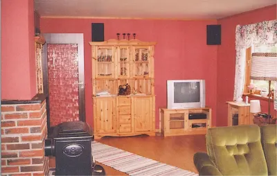 a living room with red walls and a television at Holiday Home Etne Sørstranda in Erve