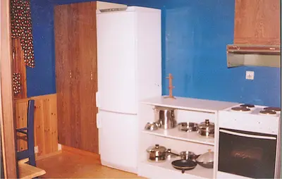 a kitchen with a white refrigerator and a stove at Holiday Home Etne Sørstranda in Erve