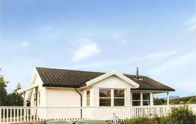 a white house with a white fence at Amazing Home In Auklandshamn With Sauna in Vestvik