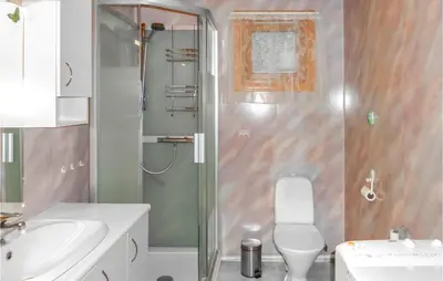 a bathroom with a shower and a toilet and a sink at Gorgeous Home In Åkra With Wifi in Åkra