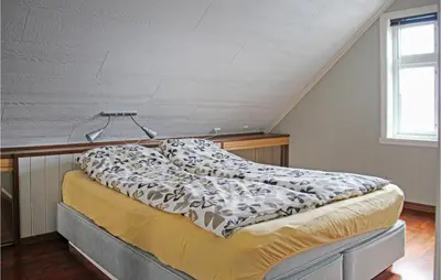 a bed in a room with an attic at Galanten in Grimsland
