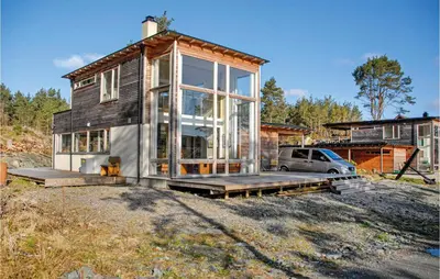 a small house with a car parked in front of it at 3 Bedroom Awesome Home In Mosterhamn in Mosterhamn