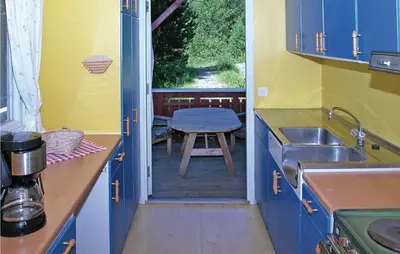 a kitchen with a sink and a table in the doorway at Stunning Home In Sandvoll in Sandvoll