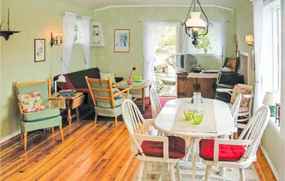 a living room with a table and chairs at Nice Home In Etne With House Sea View in Erve