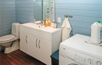 a bathroom with a sink and a toilet at Nice Home In Etne With House Sea View in Erve