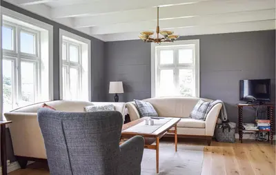 a living room with a couch and chairs and a table at Holiday Home Finnås Lykling in Vinnes