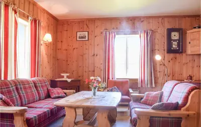 a living room with a couch and a table at Holiday Home Nordtveitgrend Nedrevågen in Hjartåker