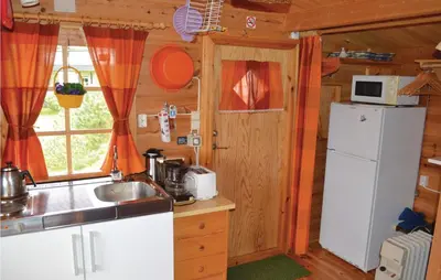 a small kitchen with a sink and a refrigerator at Cozy Home In Norheimsund in Norheimsund