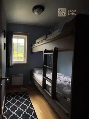 a bedroom with two bunk beds and a window at Nice apartment in Trysil ski in-out, sauna and view in Trysil