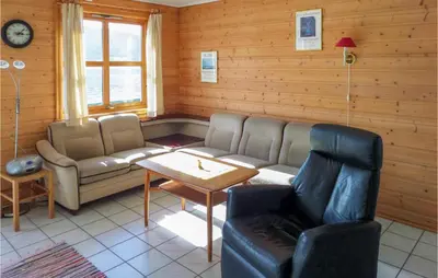 a living room with a couch and a table at Cozy Apartment In Rosendal in Rosendal