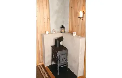 a stove in the corner of a room at Holiday Home Ålvik Ytre Ålvik in Ålvik