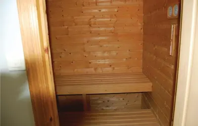 a wooden sauna with a wooden wall at Cozy Apartment In Rosendal With Sauna in Rosendal