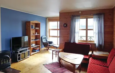 a living room with a couch and a tv at Cozy Apartment In Rosendal With Sauna in Rosendal