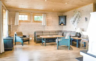 a living room with couches and a table and chairs at Eikhaugen Gjestegard in Husa