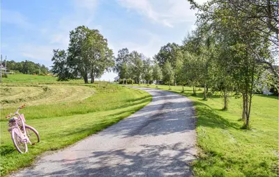 a bike parked on the side of a road at Eikhaugen Gjestegard in Husa