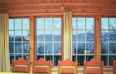 a group of chairs in front of a large window at Eikhaugen Gjestegard in Husa