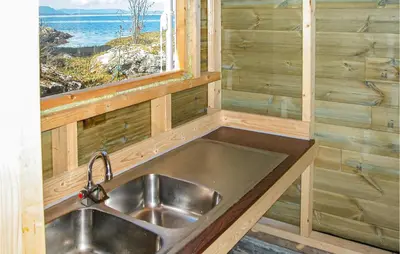 a sink in a tiny house with a window at Amazing Home In Nordtveitgrend in Hjartåker
