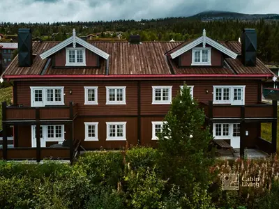 a large wooden house with white windows at Great apartment in Trysil, ski inout, wifi, sauna in Trysil