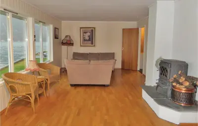 a living room with a couch and a fireplace at Holiday Home Eidfjord Simadalsv in Eidfjord