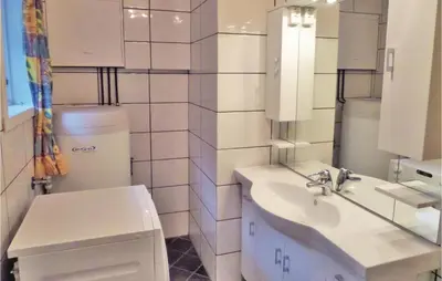 a white bathroom with a sink and a toilet at Holiday Home Eidfjord Simadalsv in Eidfjord
