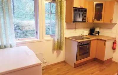 a small kitchen with a stove and a window at Holiday Home Eidfjord Simadalsv in Eidfjord