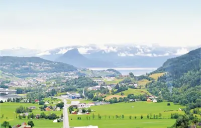 a town in a valley with a lake and mountains at Cozy Apartment In Norheimsund With Wifi in Norheimsund