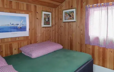 a room with a bed in a wooden room at Beautiful Home In Nordtveitgrend in Haugen