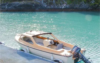 a boat is docked in a body of water at 3 Bedroom Beautiful Home In Hatlestrand in Hatlestrand