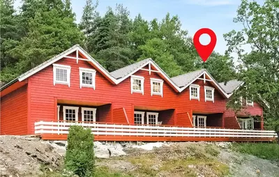 a red house with a red marker in front of it at Beautiful Home In Hatlestrand in Hatlestrand