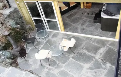 an aerial view of a patio with chairs and tables at Cozy Home In Hatlestrand With Sauna in Hatlestrand