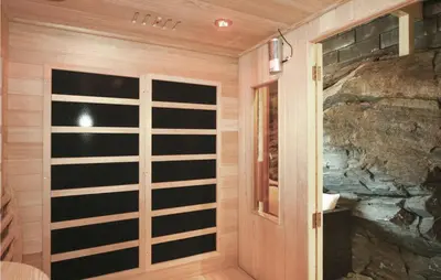 a room with a stone wall and a door at Cozy Home In Hatlestrand With Sauna in Hatlestrand