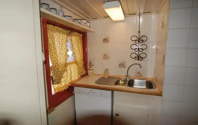 a small kitchen with a sink and a window at Petterbua in Norheimsund